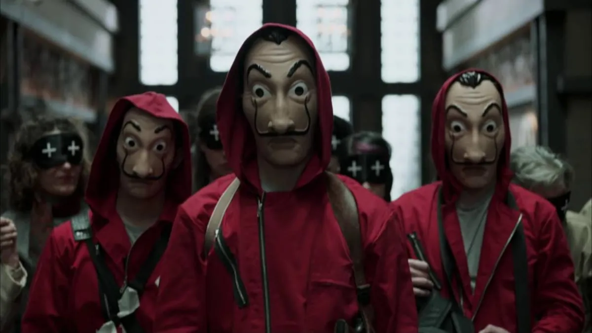Atracadores de La casa de papel con monos rojos y máscaras de Dalí